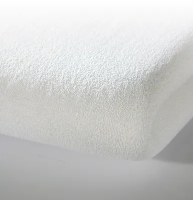 A close-up, studio shot of a folded white fitted sheet.