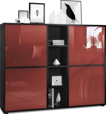 A modern highboard with red glossy doors and black matte frame, decorated with framed pictures and decorative objects on top.
