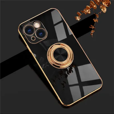 A black iPhone case with a gold ring stand is shown against a dark background with a decorative gold sprig.