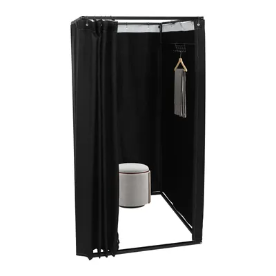 A black freestanding changing room with a stool and a scarf hanging on a hanger.