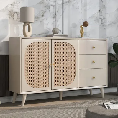 A sideboard with rattan doors and drawers, placed in a room with a marble-patterned wall and a rug.