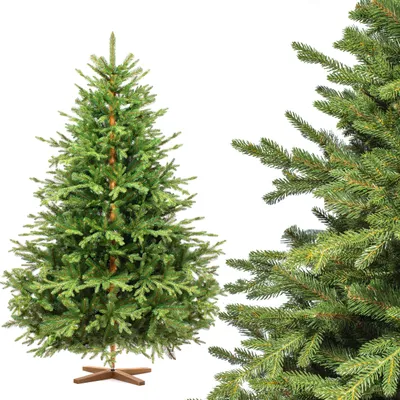 A full artificial Christmas tree with a wooden stand, shown against a white background. A close-up of the tree's branches is visible on the right side of the image.