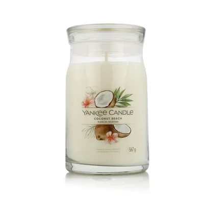 A Yankee Candle Coconut Beach scented candle in a glass jar with a lid.