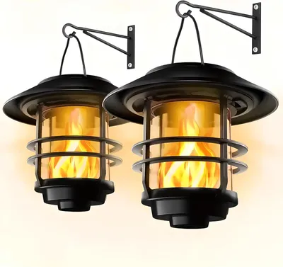 Two solar-powered lanterns with flickering flame effects are mounted on wall brackets.