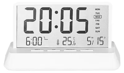 A digital alarm clock displaying the time, date, day of the week, and temperature.