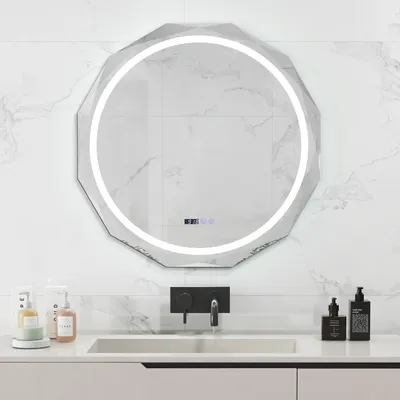 A modern bathroom vanity with a sink, faucet, and a large LED mirror mounted on a marble-tiled wall.