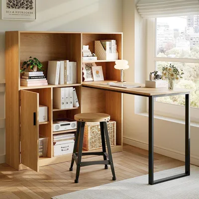 A home office setup with a desk and shelving unit next to a window.