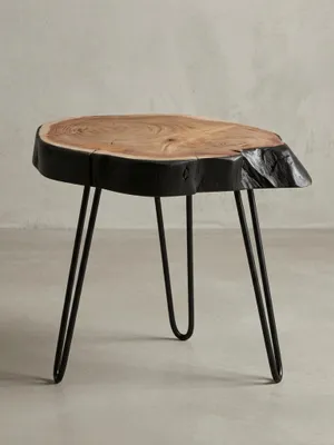 Freigestellter Beistelltisch aus massiver Akazie mit schwarzer Baumkante und schlanken Haarnadelbeinen aus Metall, Frontansicht auf weißem Hintergrund._#sku_BARWL6.475#