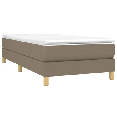 A taupe boxspring bed with a white mattress on a white background.