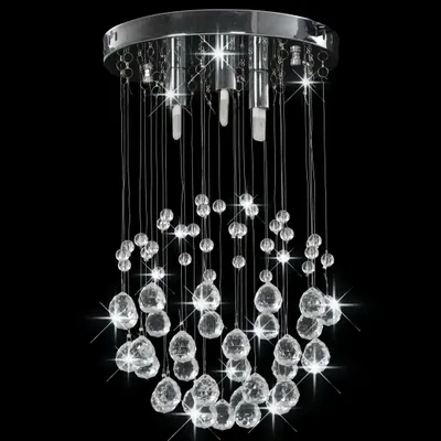 A close-up studio shot of a crystal chandelier against a black background.
