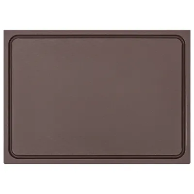 A brown cutting board with a grooved edge.