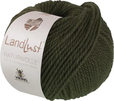 A ball of dark green yarn with a label wrapped around it.