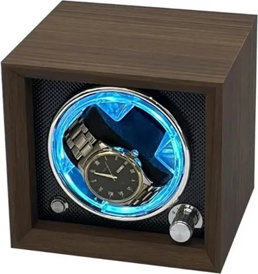 A watch winder with a watch inside, illuminated by blue LED lights.