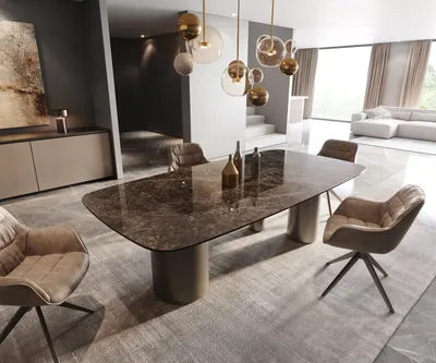 A modern dining room with a large ceramic dining table and chairs, a sideboard, and a living area in the background.
