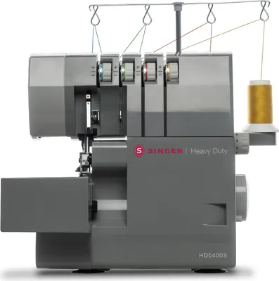 A studio shot of a gray Singer Heavy Duty sewing machine against a white background.