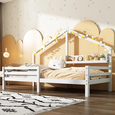 A child's bedroom with a white house-shaped bed decorated with string lights.