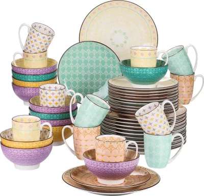 A collection of colorful ceramic tableware, including plates, bowls, and mugs, arranged in stacks and groups.