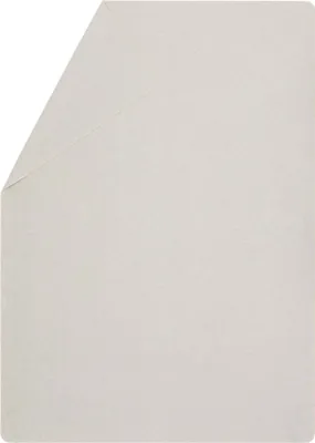 A plain white background with a corner of a white blanket folded over.