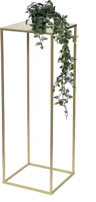 A gold metal plant stand with a potted plant on top.