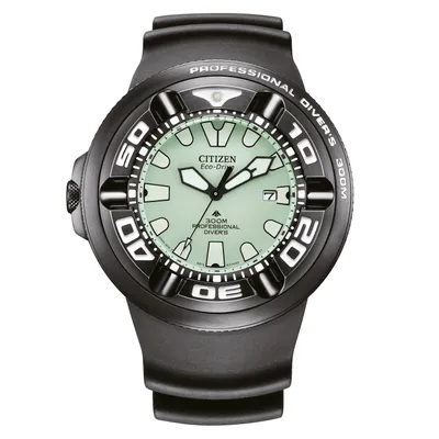 A close-up, front-facing studio shot of a black Citizen Eco-Drive professional diver's watch with a light green dial.