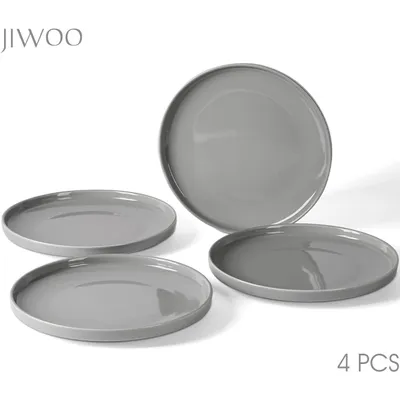 A set of four gray ceramic plates on a white background.