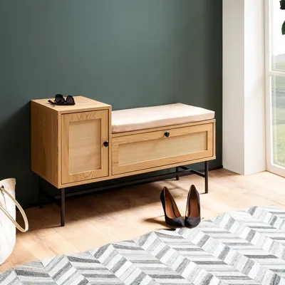 A shoe bench with storage in a hallway next to a window, with shoes and a bag nearby.