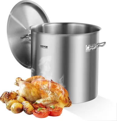 A large stainless steel pot with a lid, next to a roasted chicken and vegetables.