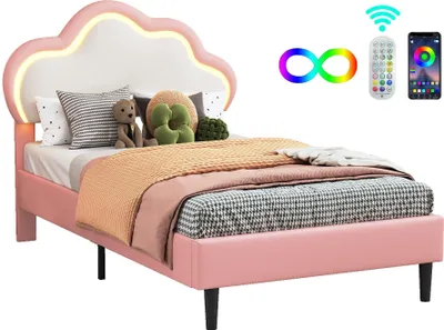 A pink bed with a cloud-shaped headboard and LED lighting, shown with pillows and blankets.