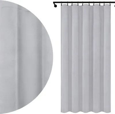 A gray curtain hanging from a curtain rod.