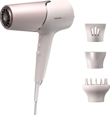 A white and rose gold Philips hair dryer with three attachments.