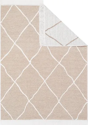 A beige rug with a white diamond pattern is shown from a top-down perspective, with one corner folded back.