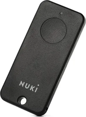 A black Nuki remote control is shown against a white background.