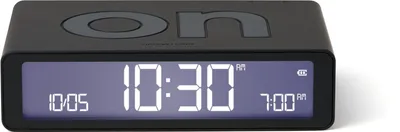 A black digital alarm clock with a digital display showing the time and alarm settings.
