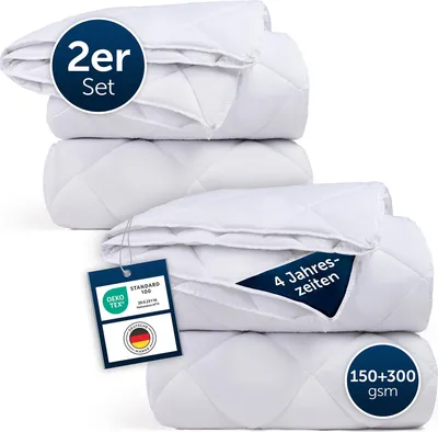 A stack of white quilted duvets, presented as a product image for e-commerce.