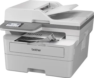 A Brother MFC-L2960DW laser printer is shown from a front-side angle against a white background. A document is partially fed into the output tray.