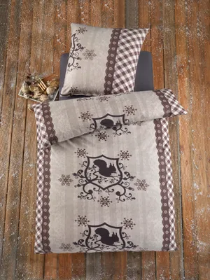 A bedding set laid out on a wooden surface.