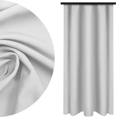 A close-up of white fabric and a white curtain hanging.