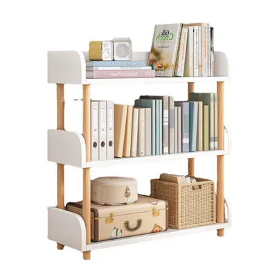 A three-tiered white bookshelf with wooden accents, filled with books and decorative items.