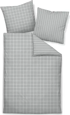 A flat lay of bedding and pillowcases with a grid and stripe pattern.