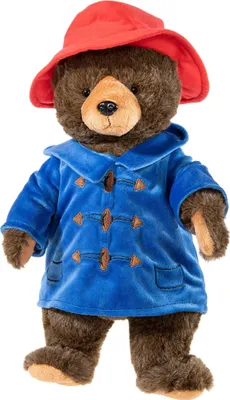 A Paddington Bear plush toy standing against a white background.
