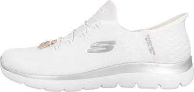 A side view of a white Skechers sneaker with silver accents.