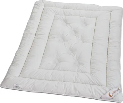 A white duvet is laid out flat on a white background.