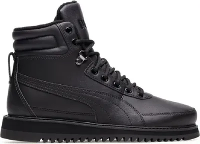 A studio shot of a black Puma boot.