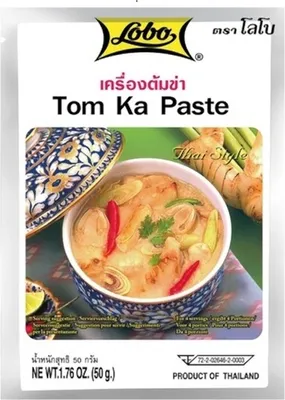 A product package for Tom Ka Paste with an image of the prepared dish.