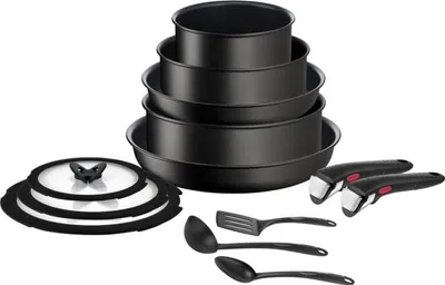 A set of black cookware and kitchen utensils is displayed against a white background.