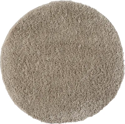 A round, beige shaggy rug is shown from a top-down perspective against a white background.