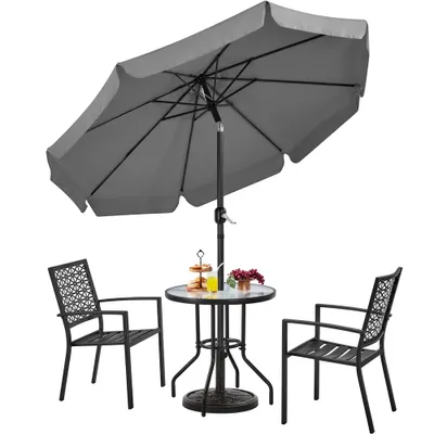 A patio set with a table, two chairs, and an umbrella.