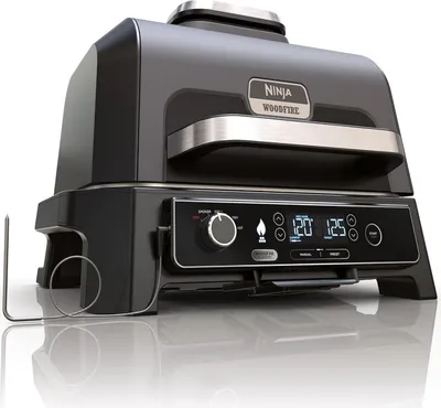 A studio shot of a black and silver Ninja Woodfire Pro XL electric grill.