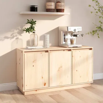 A light wood cabinet with three doors, topped with a coffee machine, a vase with greenery, and a decorative item.