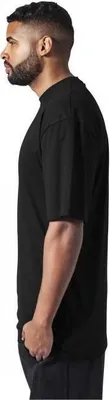 A man wearing a black t-shirt, shown from the side.